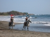 Equestrians are thrilled from the ride in the surf. / Pferdefreunde sind begeistert davon in den Wellen zu reiten.